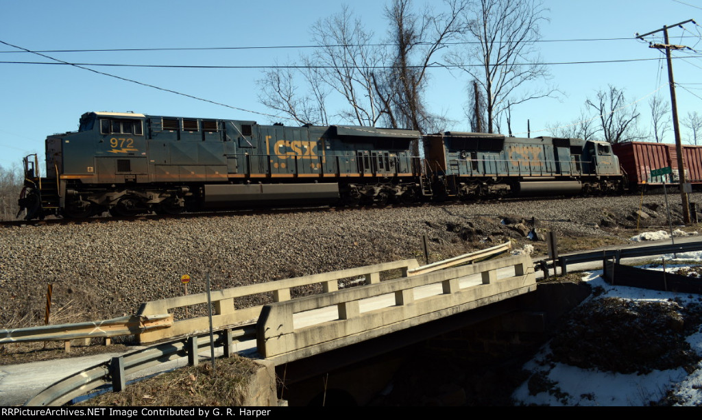 H763 heads west after meeting a grain train at Reusens